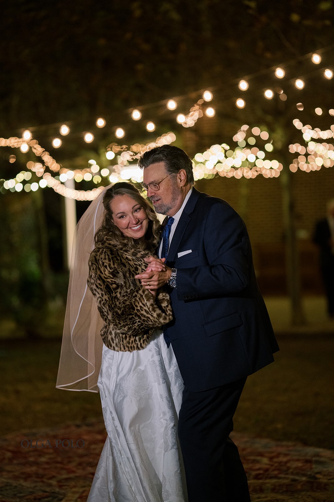 Night portrait of Ryan and Beth together beneath the reception lights