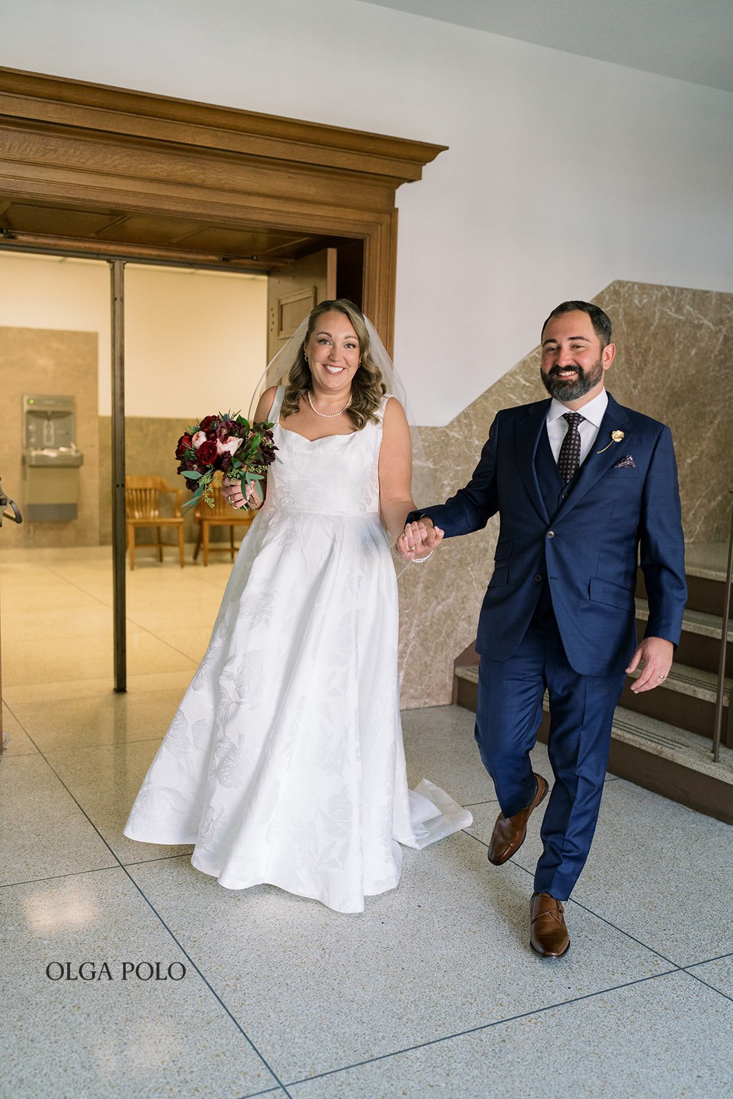 Ryan and Beth walking together through Versailles after their civil ceremony