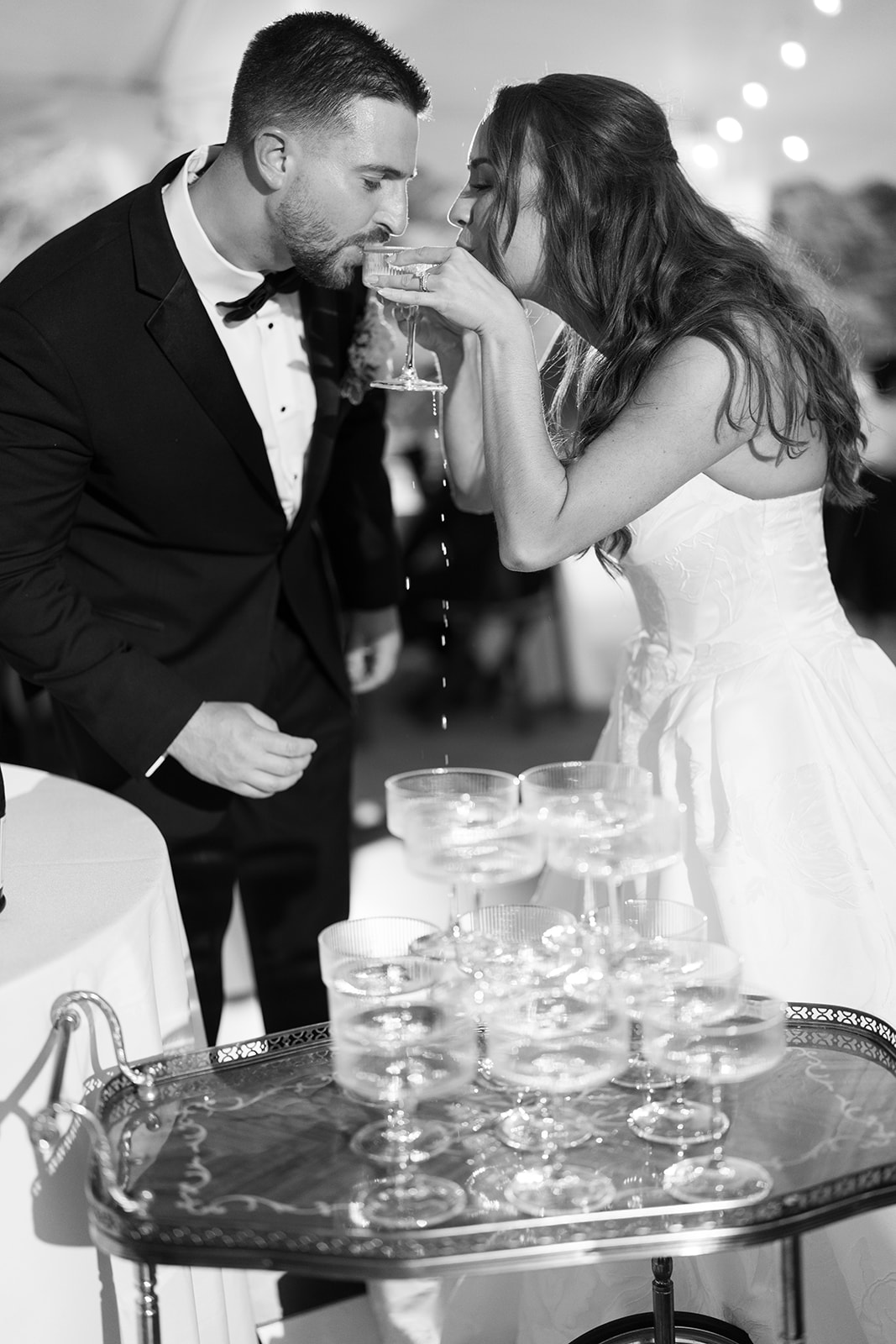 Black-and-white champagne moment from Zach and Olivia's wedding