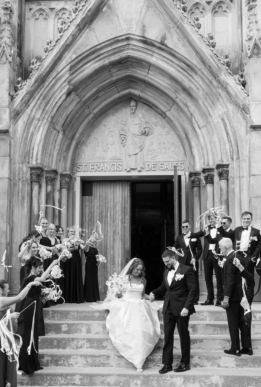 Black-and-white bridal portrait of Olivia on a staircase