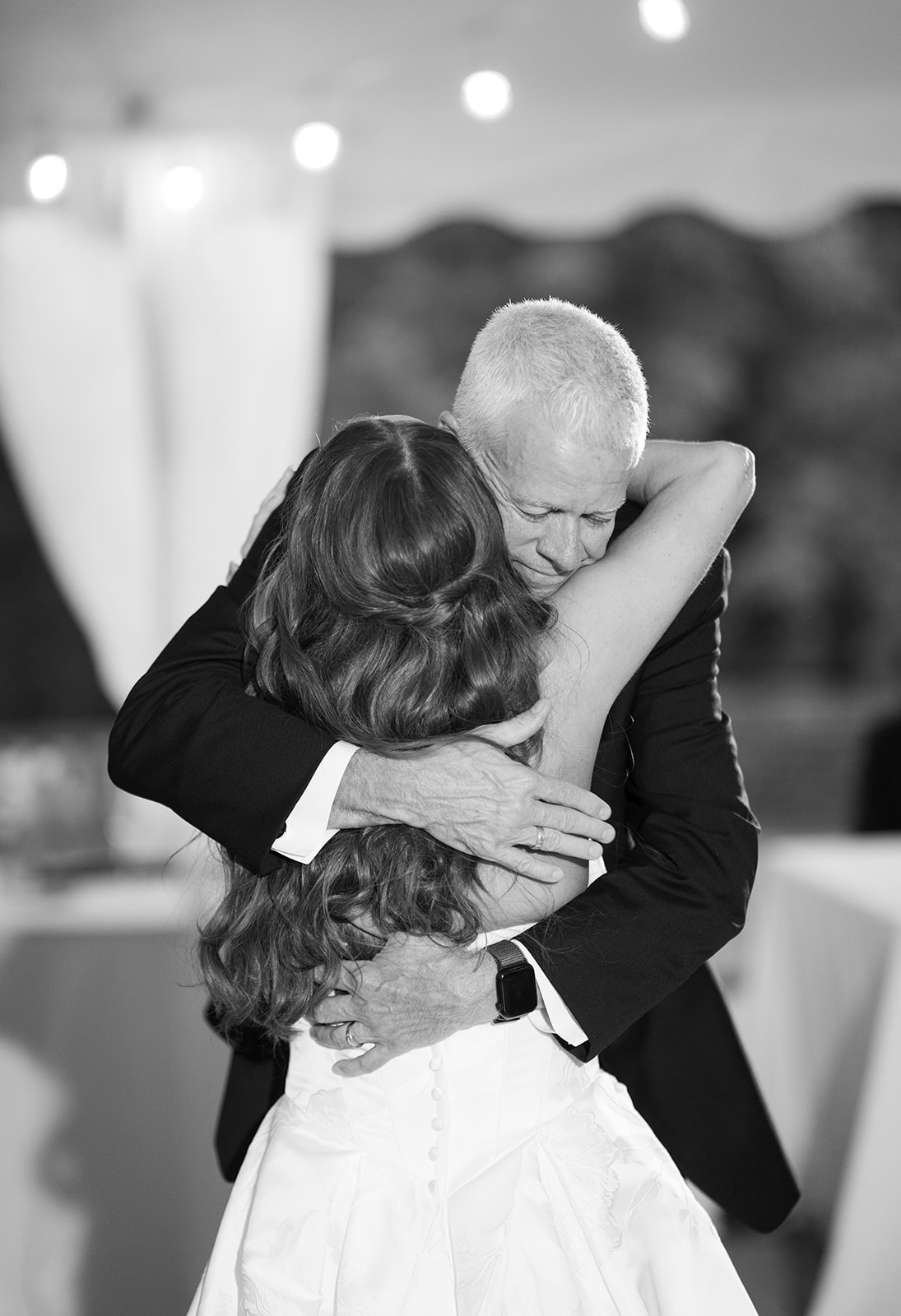 Zach and Olivia embracing in a wedding portrait