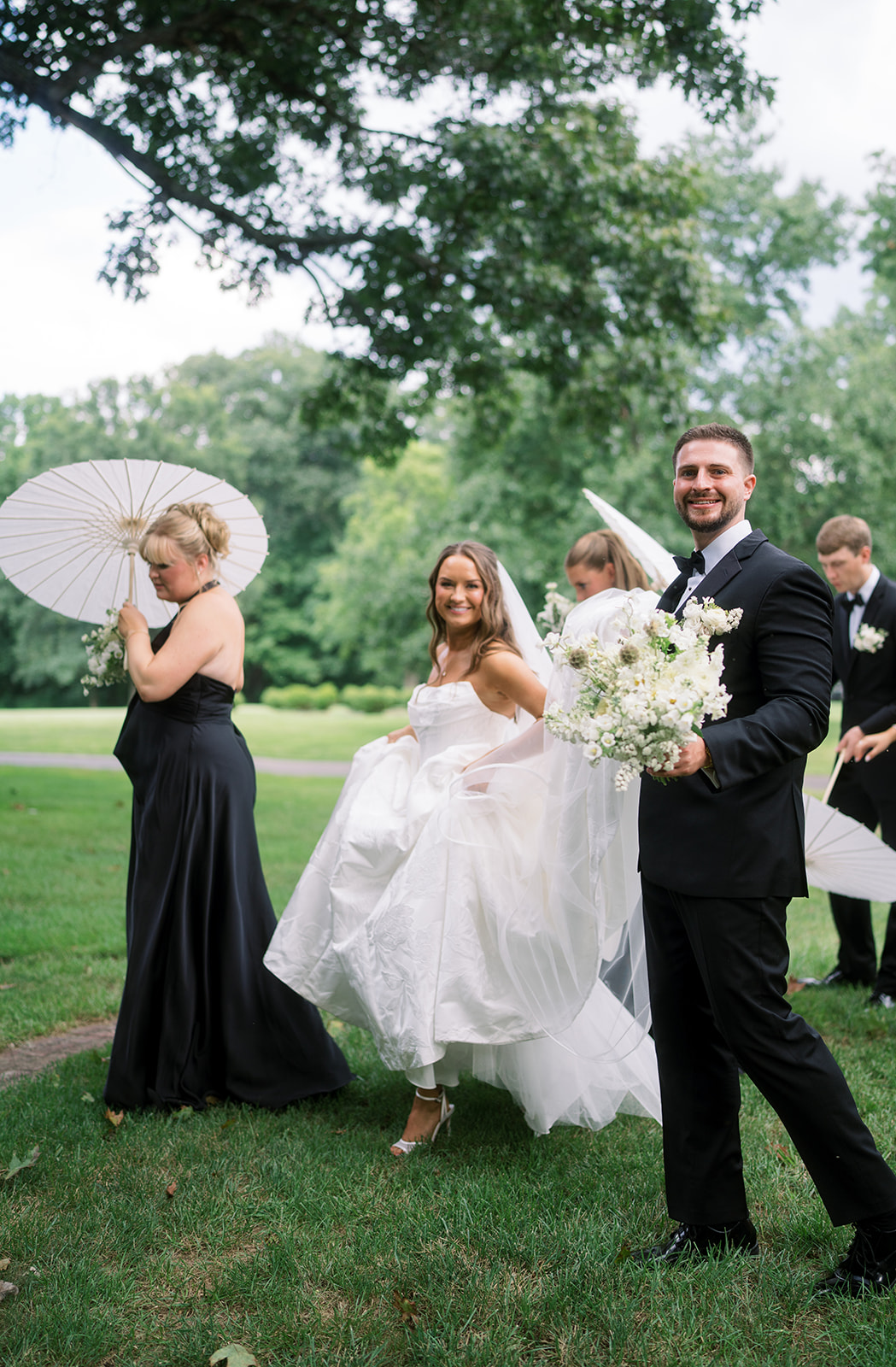 Olivia holding her bouquet in an outdoor bridal portrait, gallery view 2