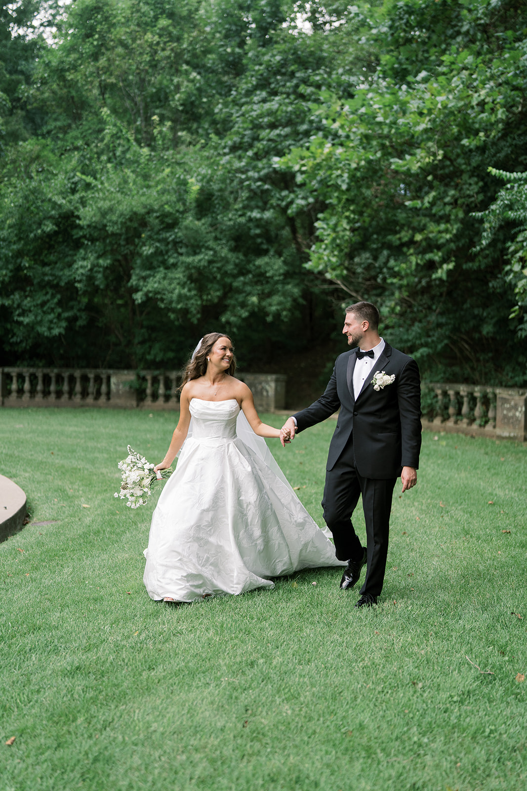 Olivia holding her bouquet in an outdoor bridal portrait, gallery view 6