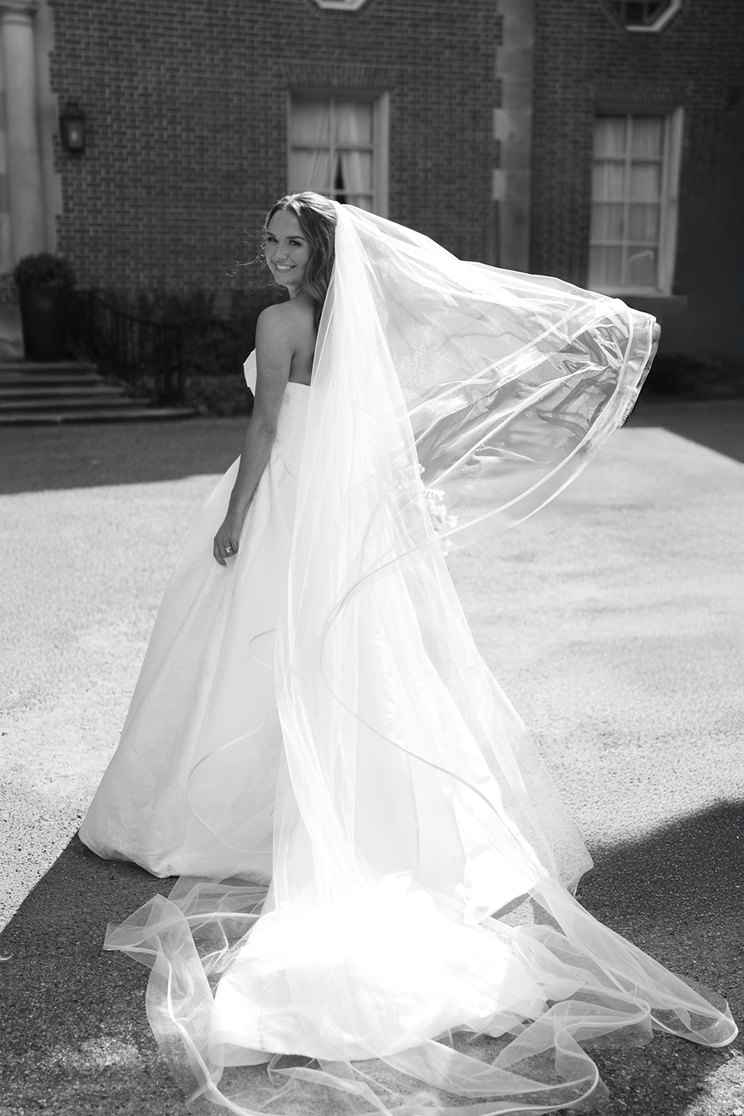 Olivia in her wedding gown during an outdoor portrait, gallery view 3